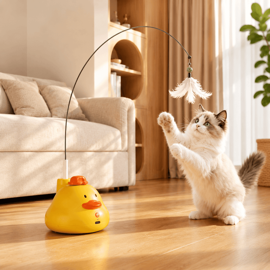 Yellow duck Noblias automatic cat teaser toy spinning its feather wand on a living room floor