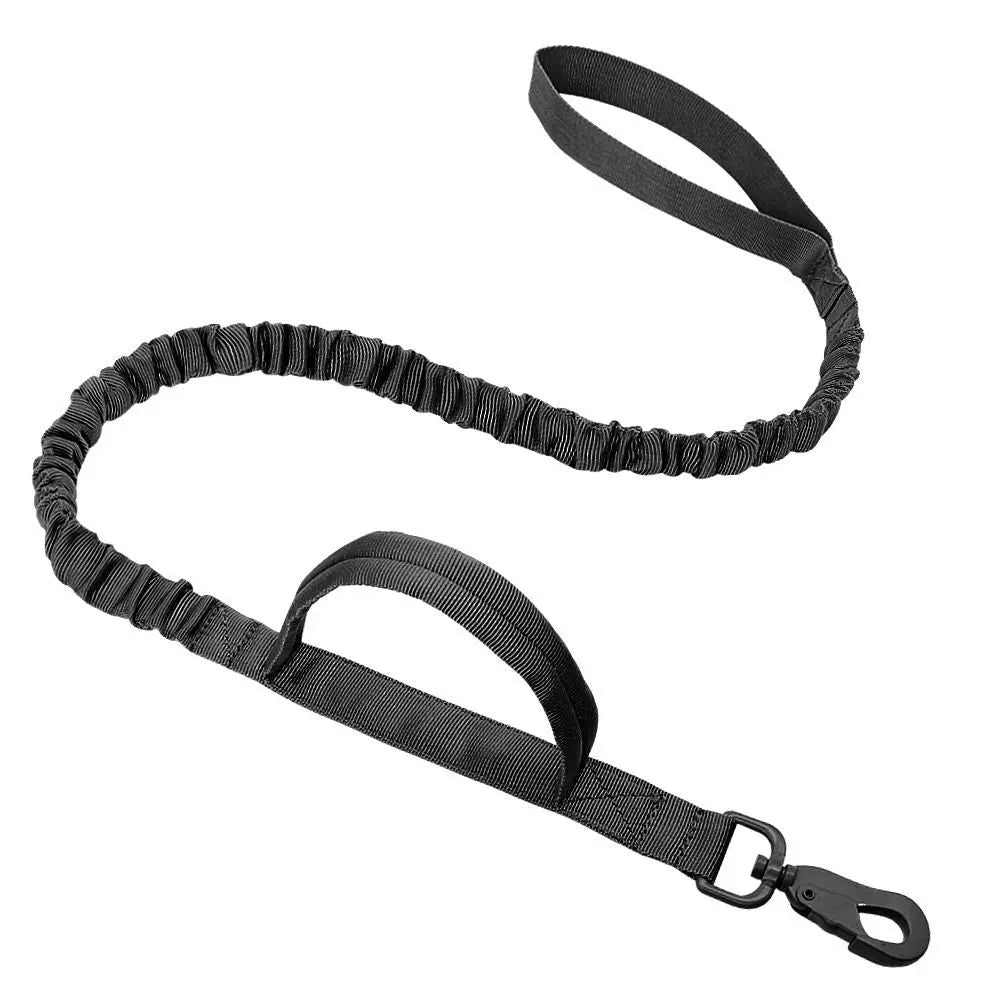 Black tactical bungee dog leash with two padded handles and a metal snap hook on a white background.