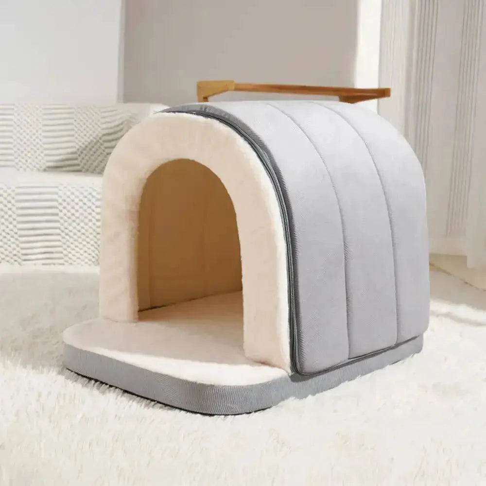 Gray enclosed cave bed photographed empty on a white rug.