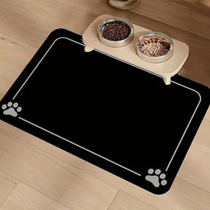 Black absorbent pet feeding mat with a light border line and paw prints in two corners under a raised double bowl.