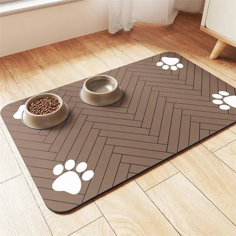 Brown chevron absorbent pet feeding mat with white paw prints, a food bowl and a water bowl.