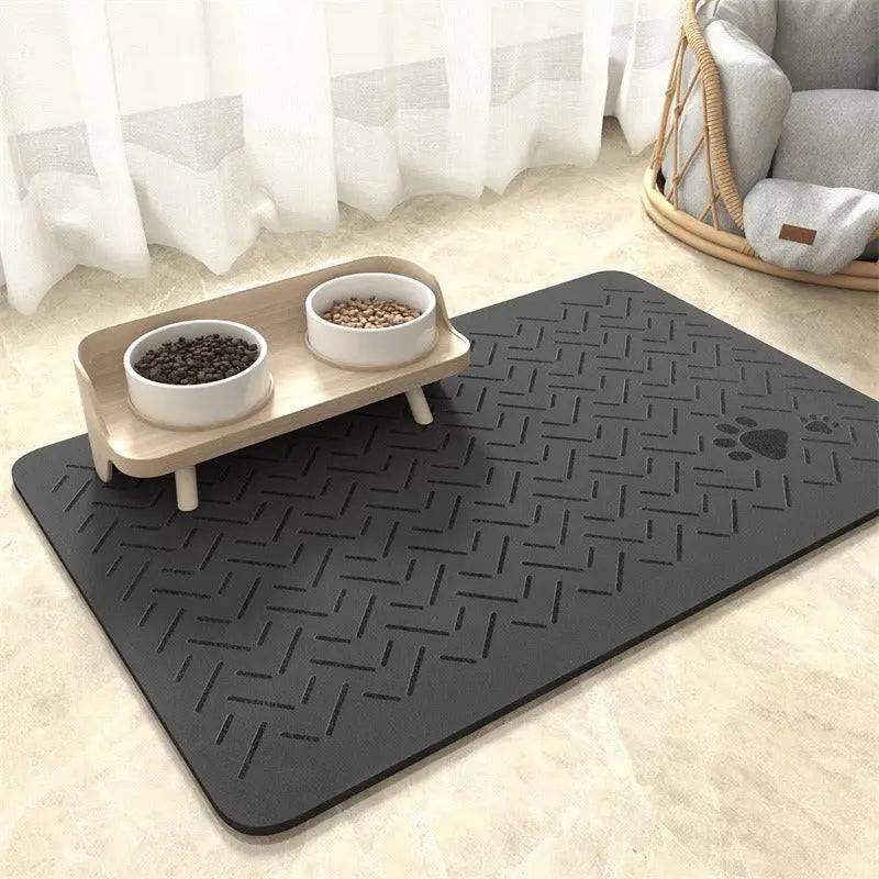 Charcoal chevron absorbent pet feeding mat with a small paw print in the corner under a raised double bowl.