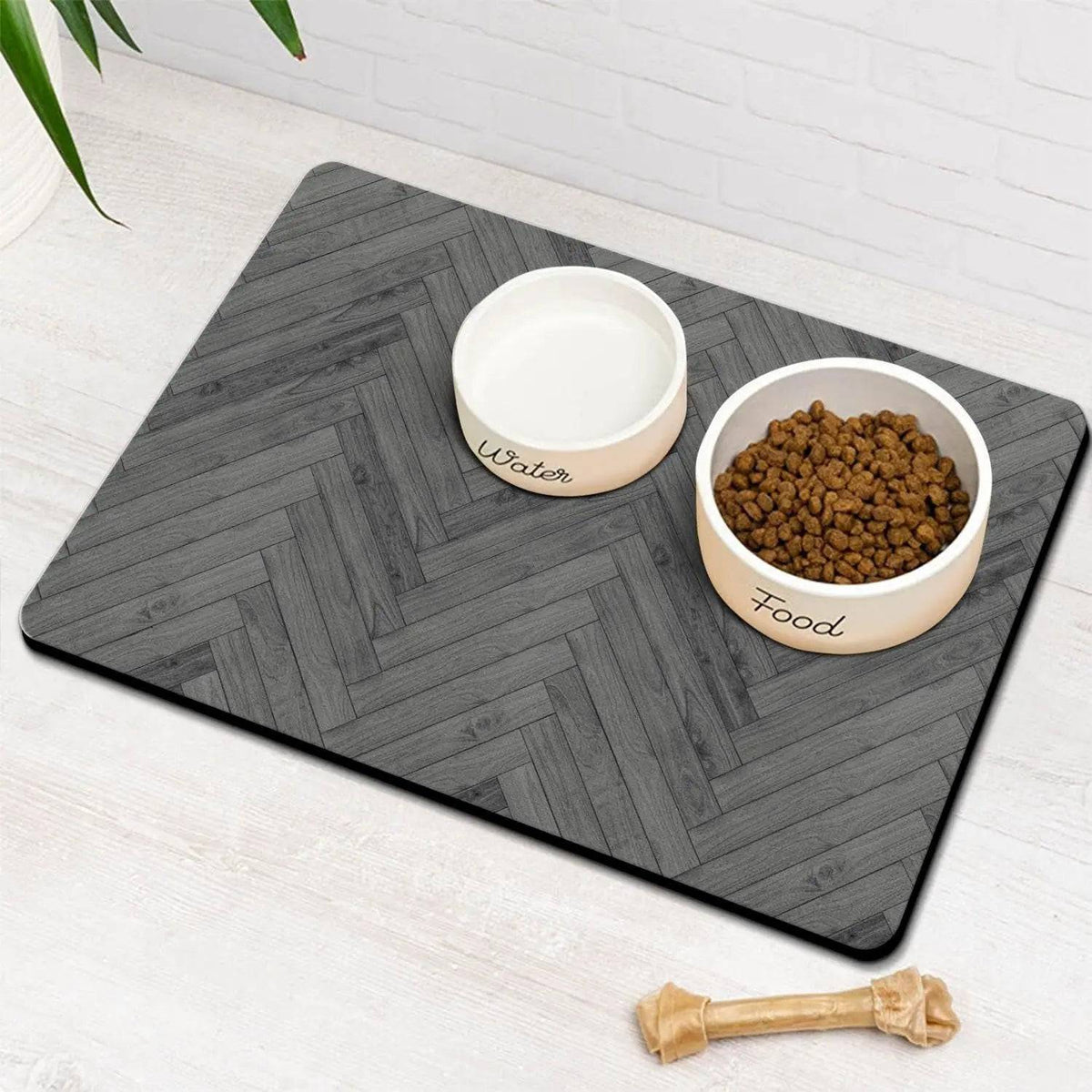 Charcoal herringbone absorbent pet feeding mat with a water bowl and a food bowl of kibble.