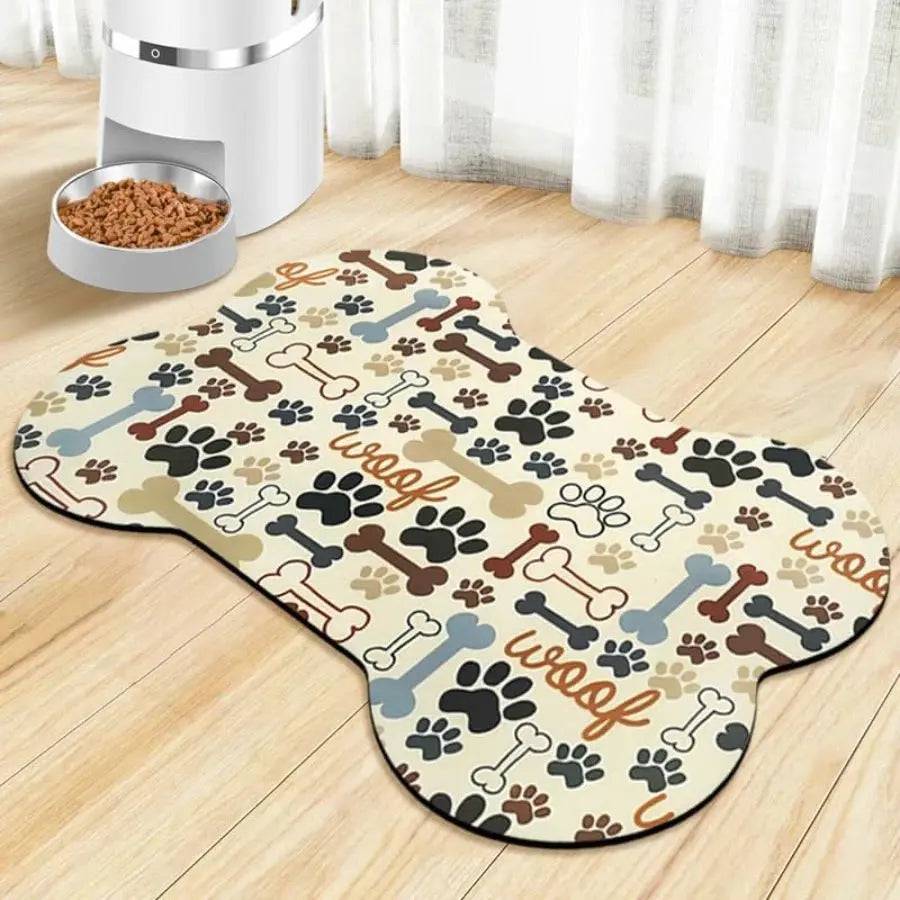 Bone-shaped cream absorbent pet feeding mat printed with woof lettering, bones and paw prints.