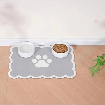 Cloud-shaped gray absorbent pet feeding mat with a white paw print, a water bowl and a food bowl.