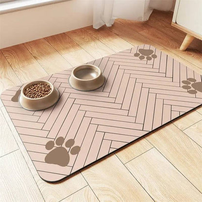 Dusty pink chevron absorbent pet feeding mat with taupe paw prints, a food bowl and a water bowl.