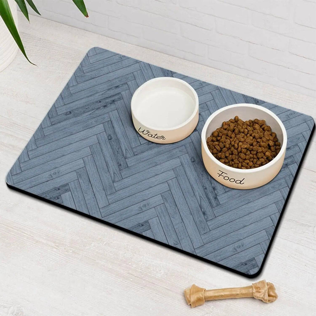 Slate blue herringbone absorbent pet feeding mat with a water bowl and a food bowl of kibble.