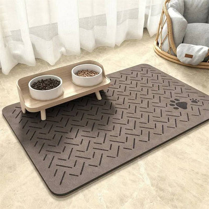 Taupe chevron absorbent pet feeding mat with a small paw print in the corner under a raised double bowl.