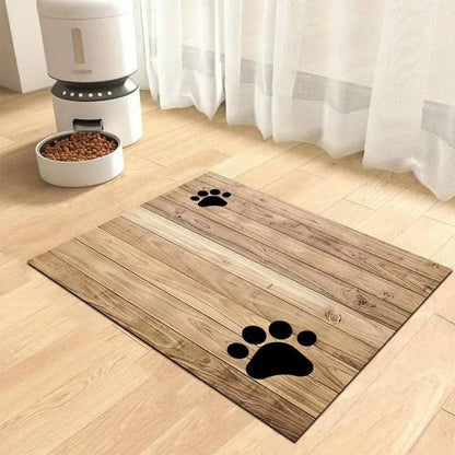 Wood plank print absorbent pet feeding mat with two black paw prints, in front of an automatic feeder.