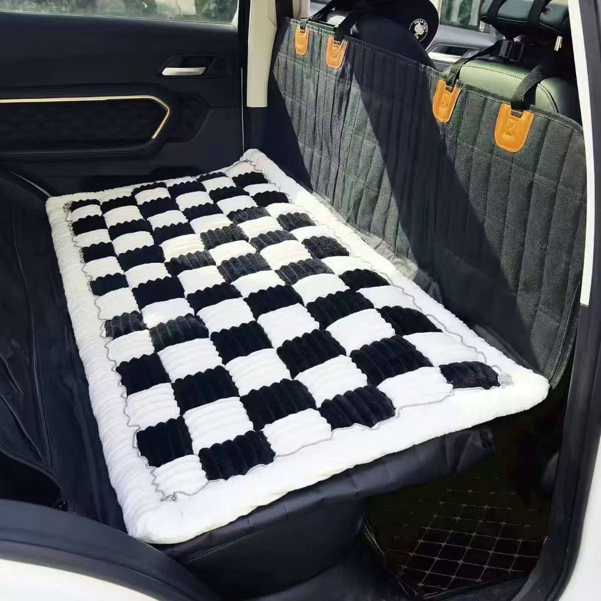 The Noblias back seat dog bed mat in the black large check style, fitted across a rear bench.