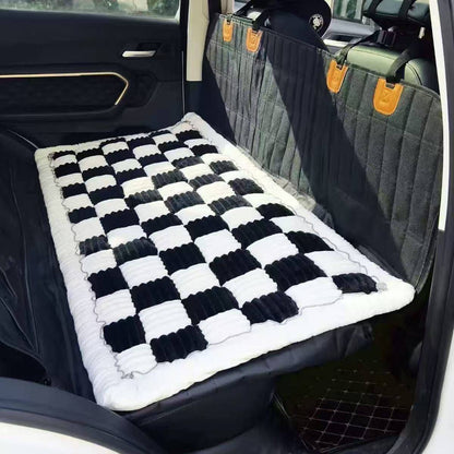 The Noblias back seat dog bed mat in the black large check style, fitted across a rear bench.