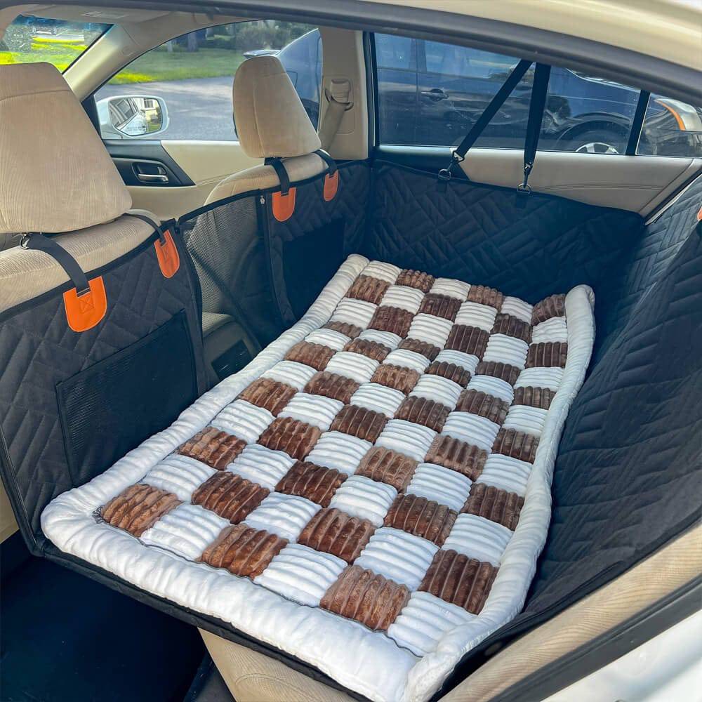 The Noblias back seat dog bed mat in the brown check style, laid across the rear seat.