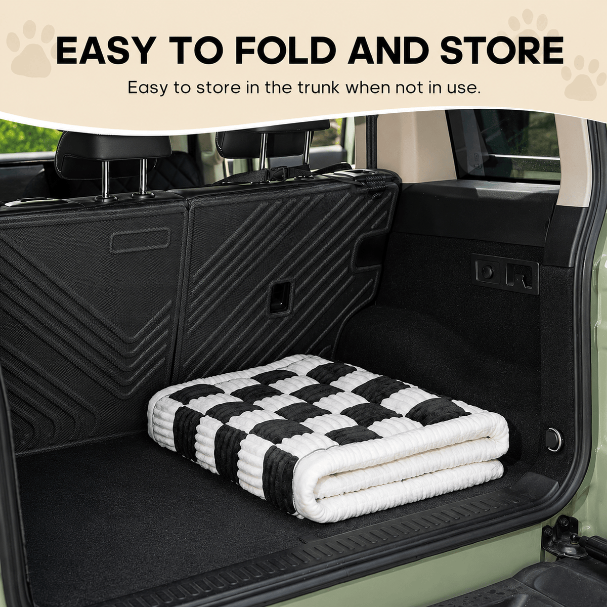 The Noblias back seat dog bed mat folded into a compact roll in the trunk of a car.