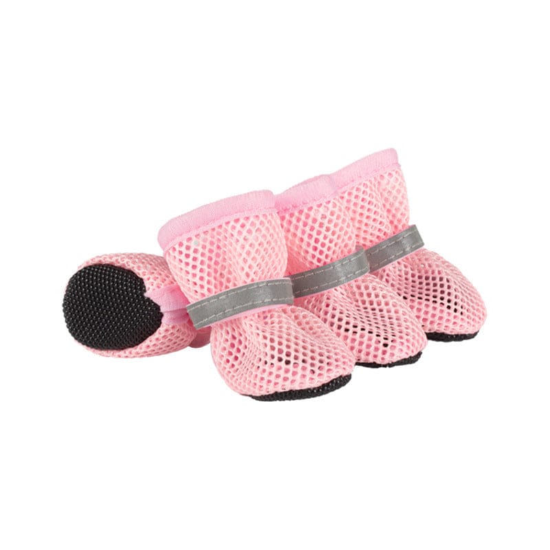 Set of four pink breathable mesh dog shoes with grey reflective straps and black rubber soles on a white background.