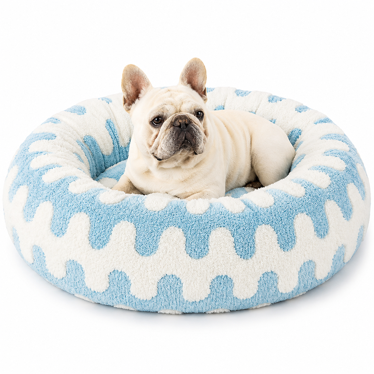 French bulldog lying in the blue wave print calming donut dog bed.