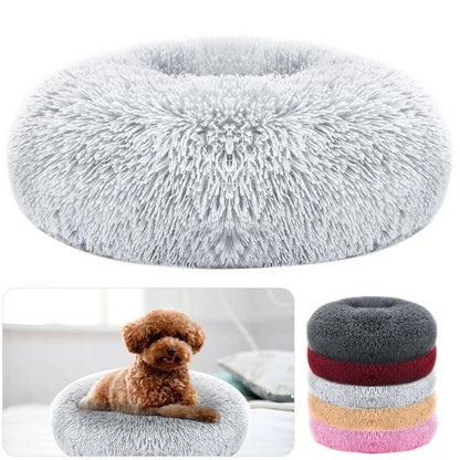 Gray faux fur donut bed shown from above, with a poodle curled inside one and the bed stacked in its other colors