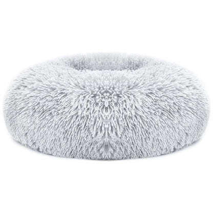 Light gray long faux fur donut dog bed on a white background