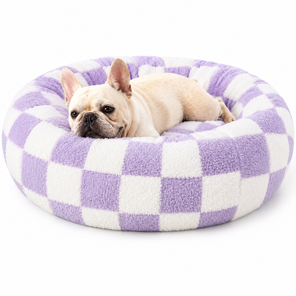 French bulldog resting in the purple checkerboard calming donut dog bed.