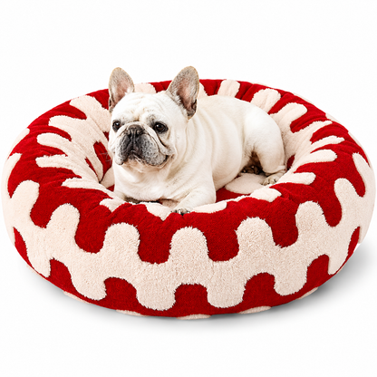 French bulldog lying in the red wave print calming donut dog bed.