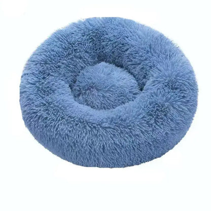Blue long plush round calming dog bed on a white background