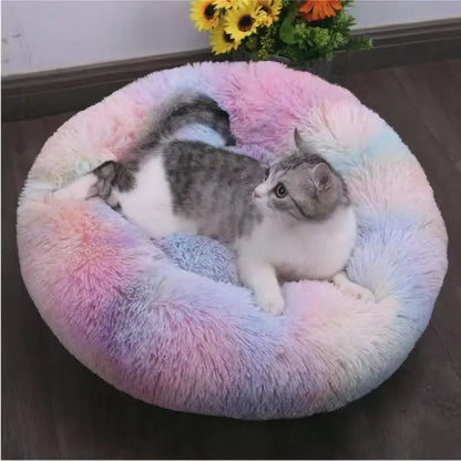 Two cats resting in a pastel tie-dye plush calming dog bed