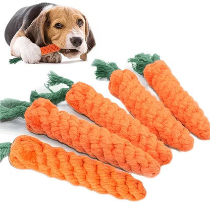 Beagle chewing a Noblias carrot dog toy with several braided orange rope carrots laid in front