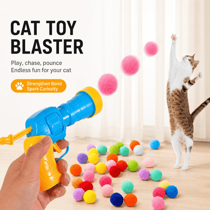 Cat leaping for a pom-pom ball fired from the cat toy blaster, with plush balls scattered on the floor