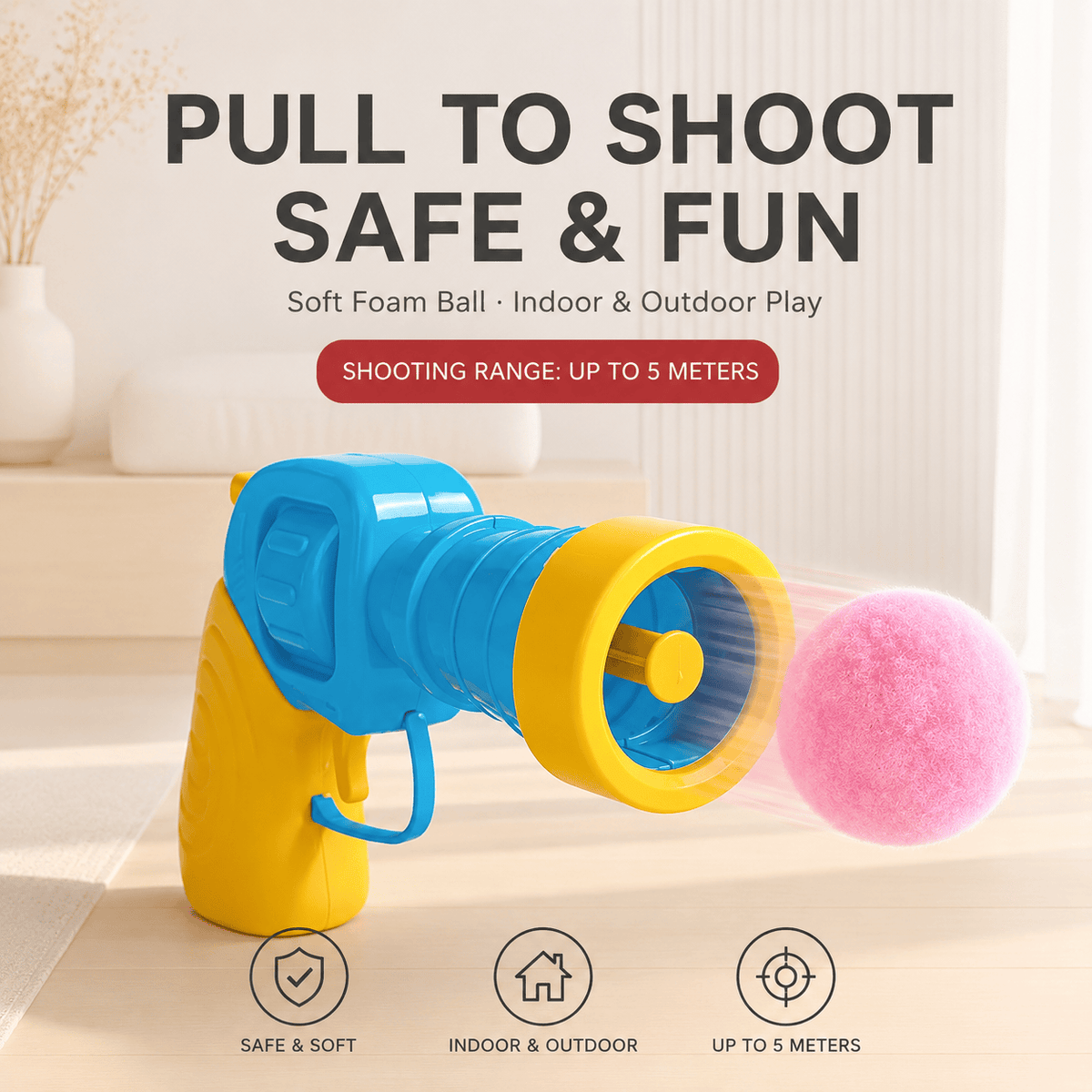 Close-up of the cat fetch toy launcher with a pink pom-pom ball loaded, labeled pull to shoot, soft ball, indoor and outdoor play