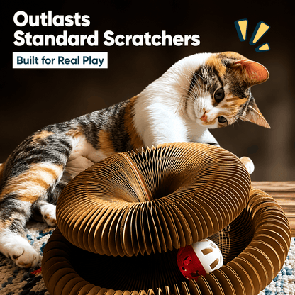 Calico cat lying across the stretched-out cardboard scratcher with the bell ball in the track, under a banner reading outlasts standard scratchers, built for real play