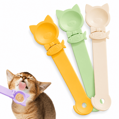 Kitten licking puree from the purple cat-eared Noblias treat squeeze spoon, with the yellow, green and cream spoons standing behind it