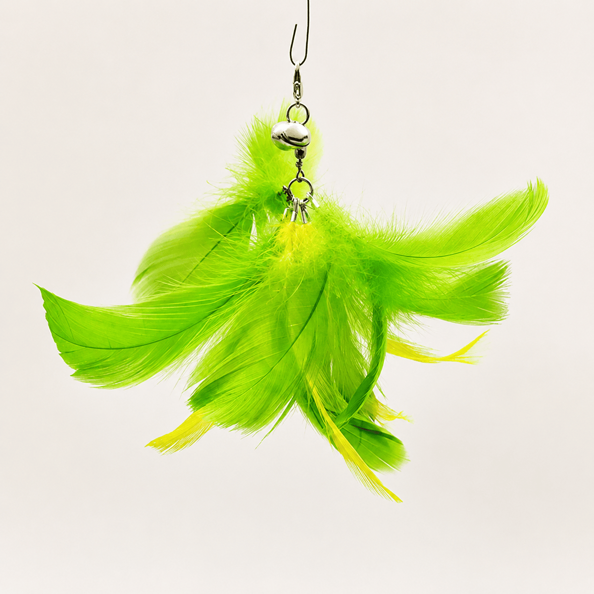 Bright green feather replacement head for the Noblias cat wand toy, hanging from its metal clip and bell.