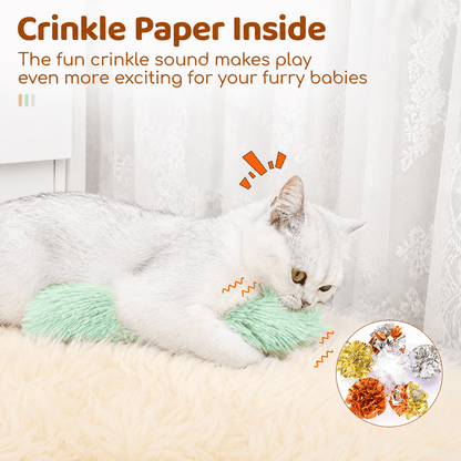 Cat biting the green Noblias tail kicker toy, with the crinkle paper inside that rustles as it plays.