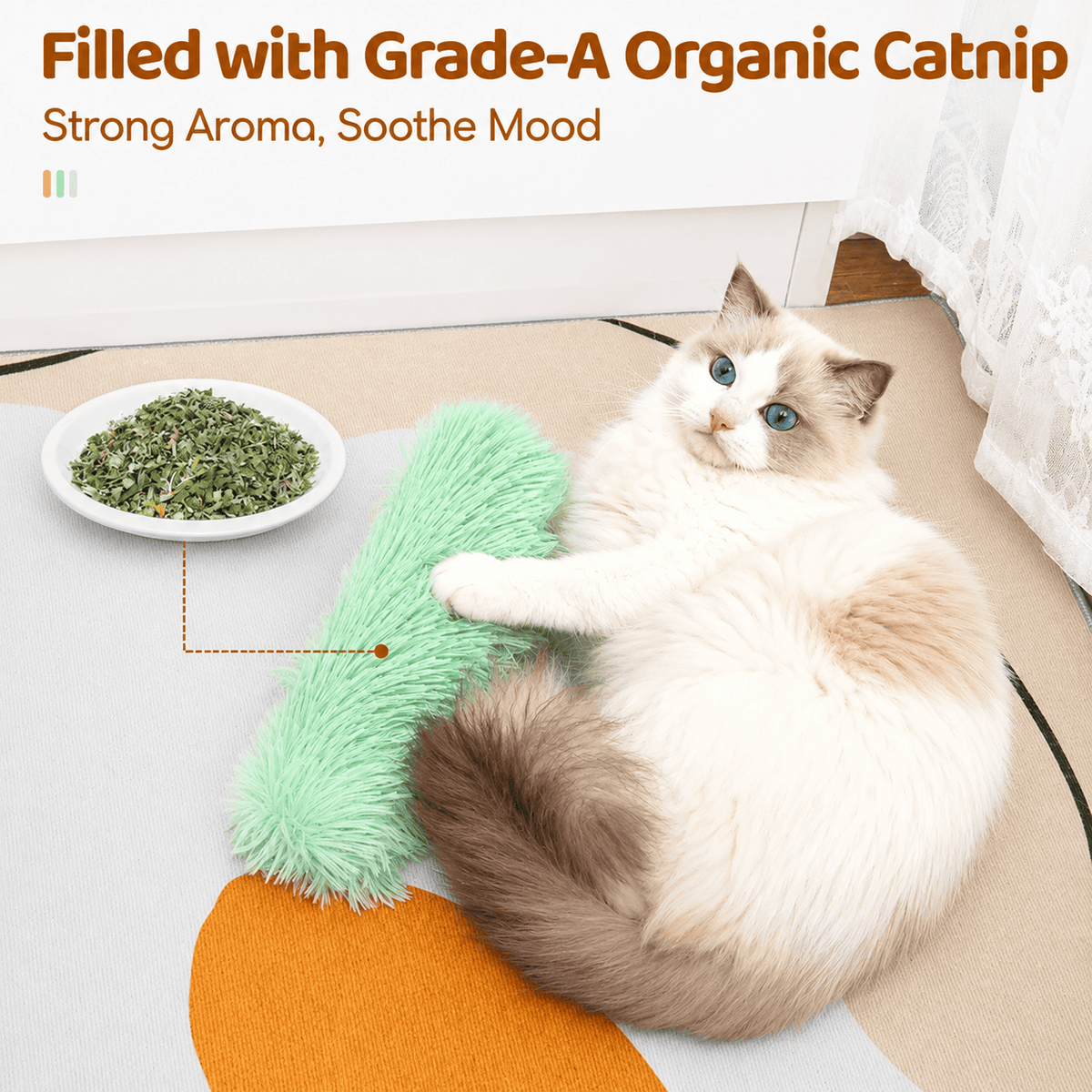 Ragdoll cat lying beside the green Noblias tail kicker toy and a dish of the organic catnip packed inside it.