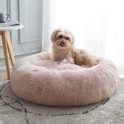 Pink Noblias cloud calming donut pet bed with a shih tzu sitting up in the middle.