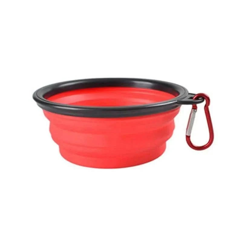 Red Noblias collapsible silicone travel bowl for dogs and cats with its carabiner clip attached.
