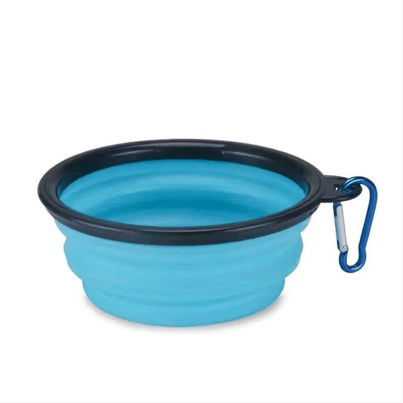 Sky blue Noblias collapsible silicone travel bowl with a black rim and carabiner clip.
