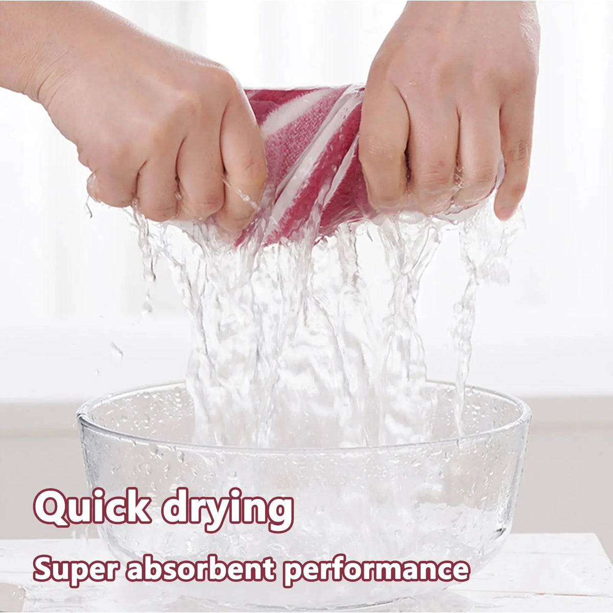 The Noblias dog bathrobe being wrung out by hand over a glass bowl, water pouring from the fabric to show how much it absorbs.