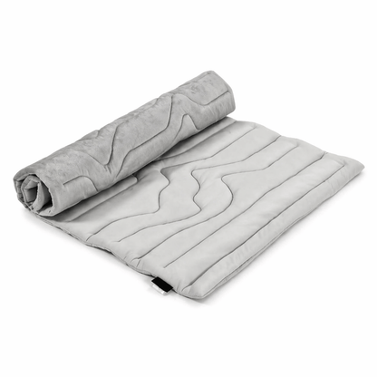 Gray Noblias self cooling dog mat, part rolled to show the quilted cooling face.