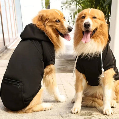 Two Golden Retrievers wearing black fleece dog hoodies outdoors, showing the hood and body fit