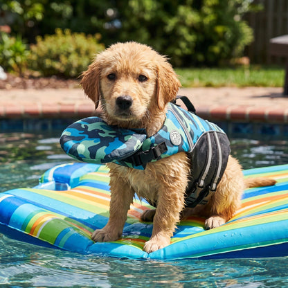 Golden Retriever puppy standing on a pool float in the blue camo dog life jacket with the chin float under its neck