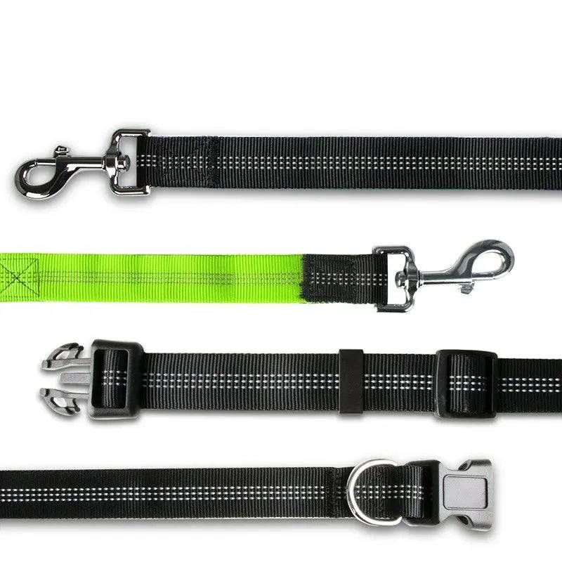 Close-up of the running belt hardware showing the heavy-duty swivel clip, the green padded traffic handle, the reflective webbing and the belt buckle with its D-ring