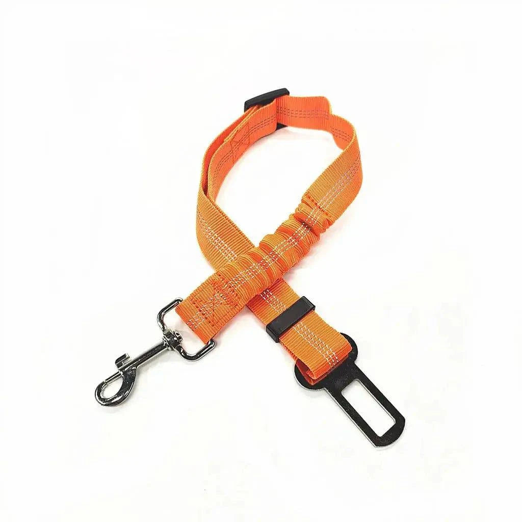 Orange bungee dog seat belt laid flat, showing the braided strap, sliding buckle and swivel hook