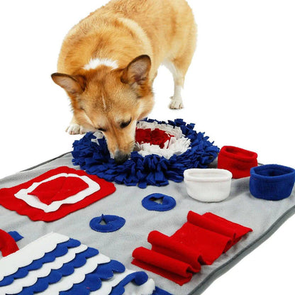 Corgi pushing its nose into the ruffled fleece circle of the snuffle mat to reach a treat