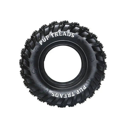 The black rubber dog tire chew toy on its own, showing the treaded outer surface and open center