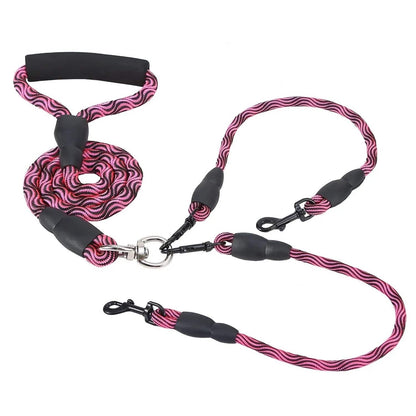 Rose red double dog leash coiled to show the foam handle, splitter and two swivel snap hooks