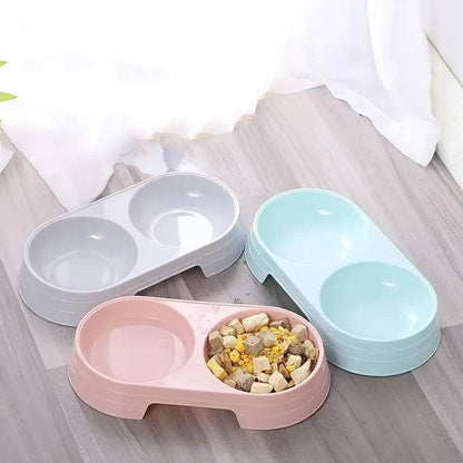 Gray, pink and blue double pet bowl sets grouped together, one holding kibble
