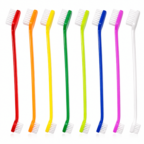 Eight double ended pet toothbrushes laid side by side in red, orange, yellow, green, blue, pink and white.