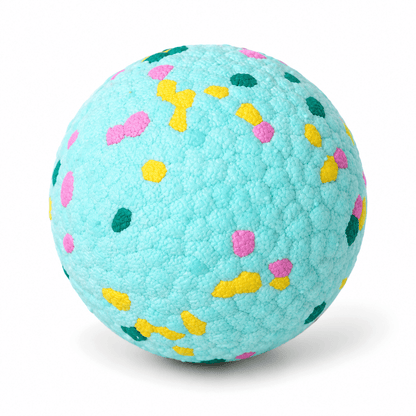 Mint green durable dog chew ball with pink, yellow and teal speckles on a white background.
