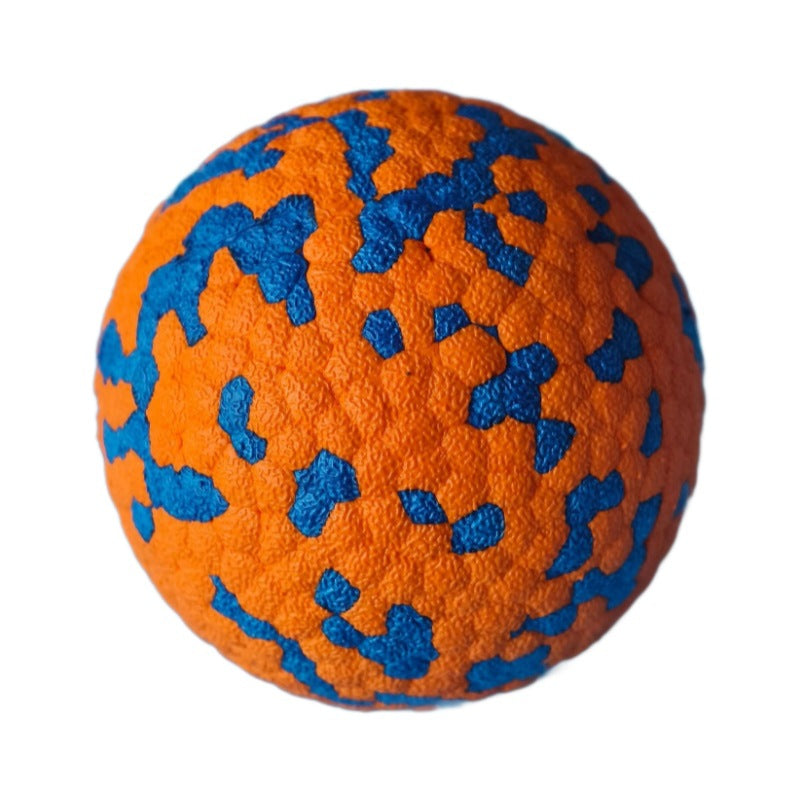 Orange durable dog chew ball with blue speckles on a white background.