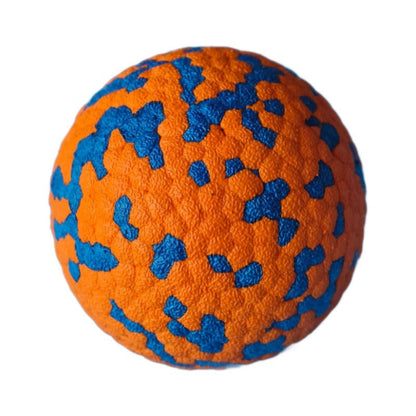 Orange durable dog chew ball with blue speckles on a white background.